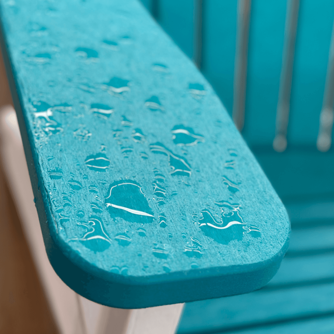 Close up of blue poly adirondack chair with rain drops